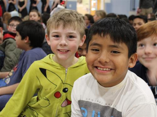 two elementary students smiling at camera 